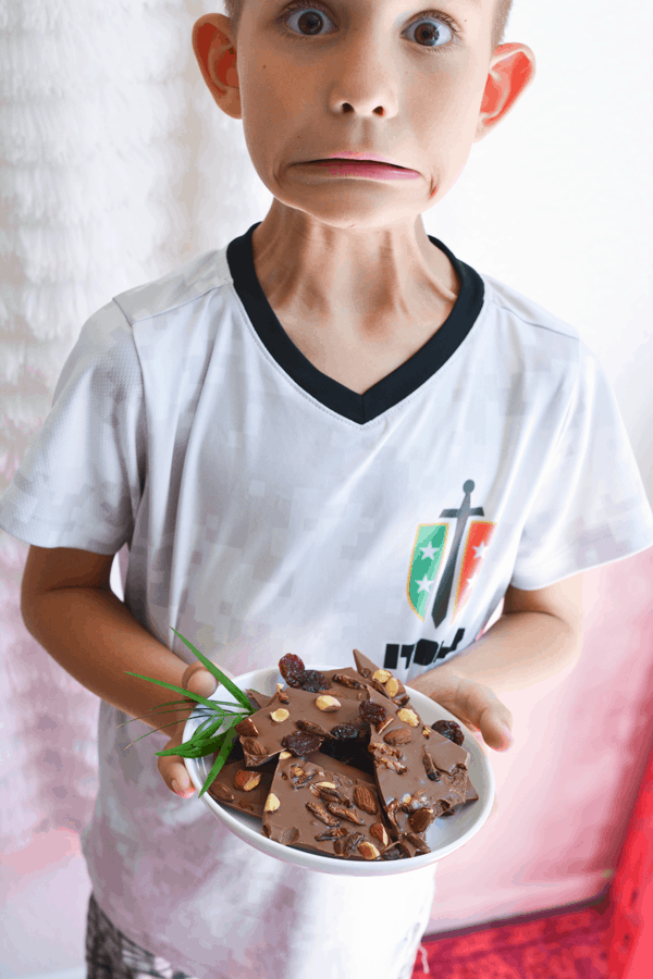 Young boy with chocolate bark featuring roasted edible crickets! 