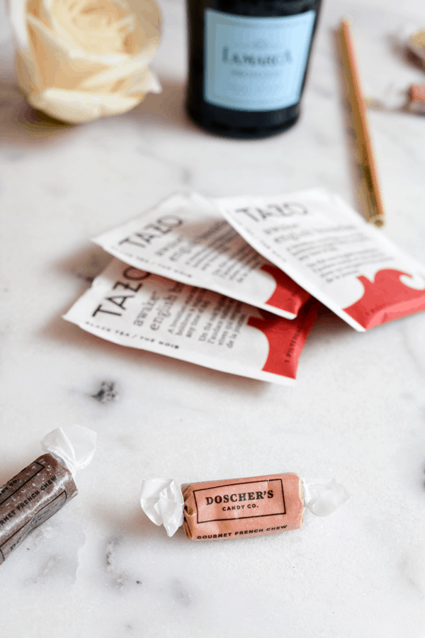 Candy and tea on a table to put into a gift basket gift idea with a Netflix subscription. 
