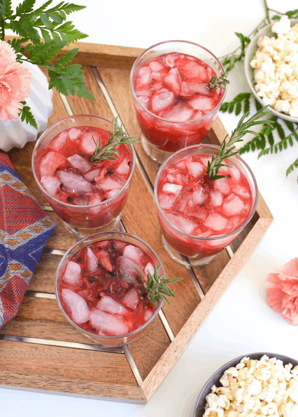 A top view of cocktail glasses holding a red Blackberry Whiskey Lemonade cocktail idea.