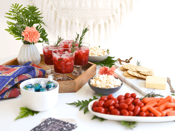 A table set up for a girl's night in with 4 glasses of Blackberry Whiskey Lemonade Cocktail