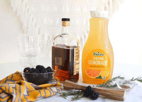 Ingredients to make Blackberry Whiskey Lemonade cocktail on a table