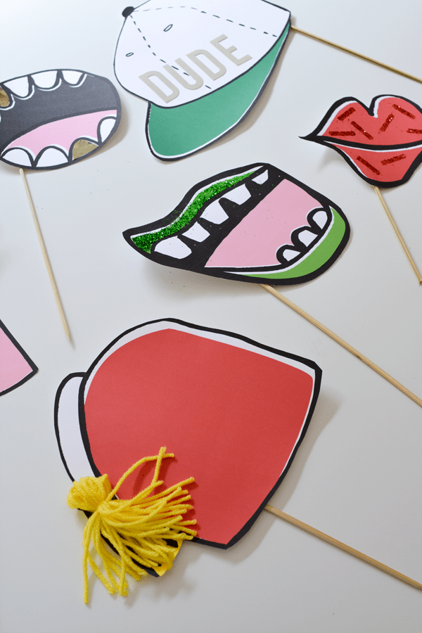 Close up of printable photo booth props on a table. 