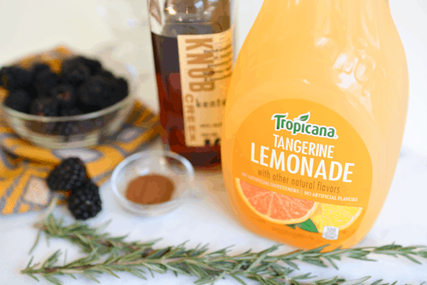 A bottle of lemonade next to other ingredients to make a cocktail