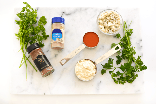 Ingredient to make Tater Tots with Buffalo Aioli on a marble cutting board.