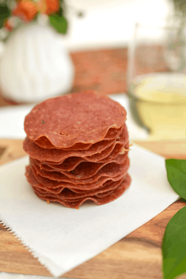 Baked salami party appetizer on a piece of parchment paper.