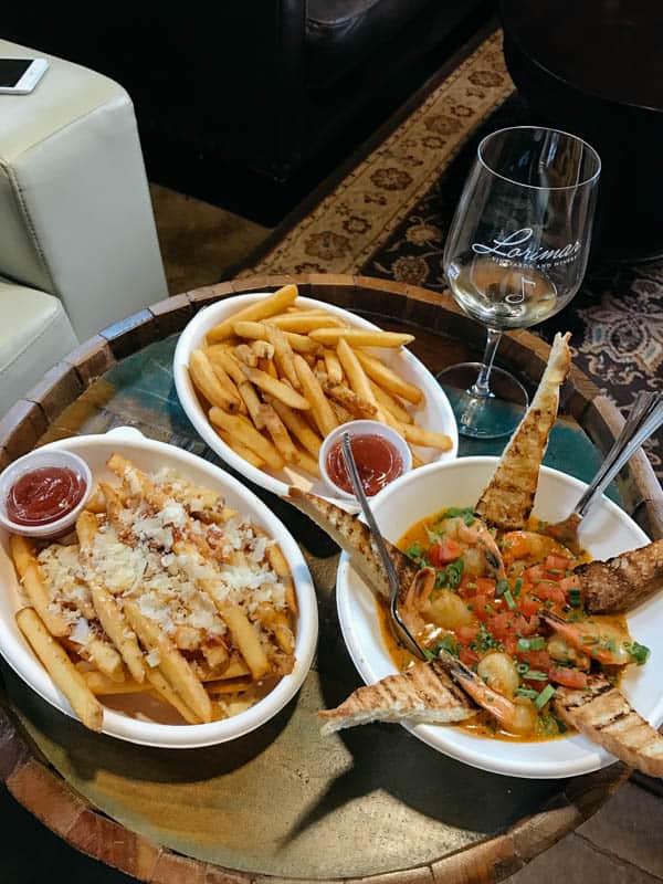 Fries and other dishes on a wine barrel table at Lorimar Winery. 