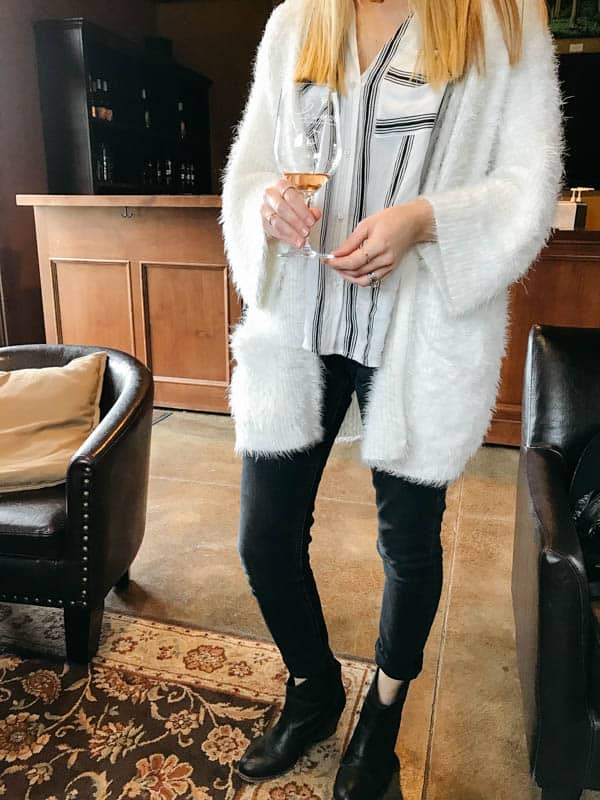 Woman holding a glass of wine in a Temecula Winery. 