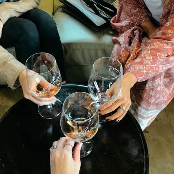 Three women cheersing with wine glasses.