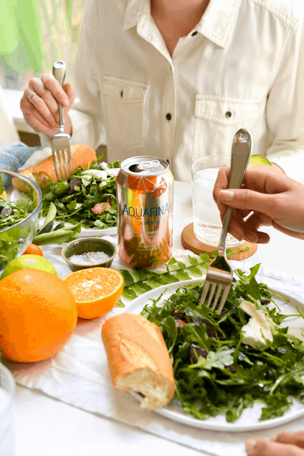 Two women enjoying salad at a table. 