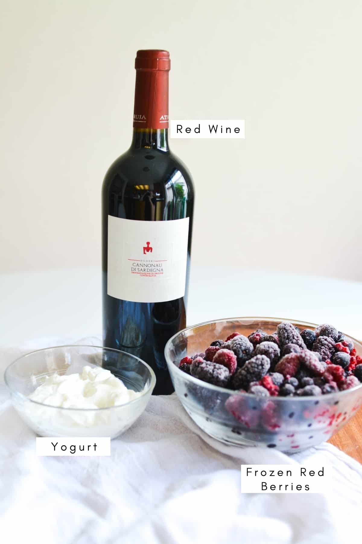 Labeled ingredients to make a smoothie with red wine.