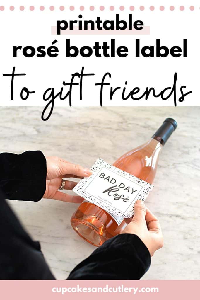 Text- printable rose bottle label to gift friends with an woman adding a label to a bottle of rose wine.