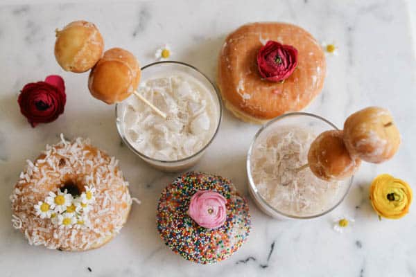 Overhead view of donuts and Coffee White Russians on a table. 