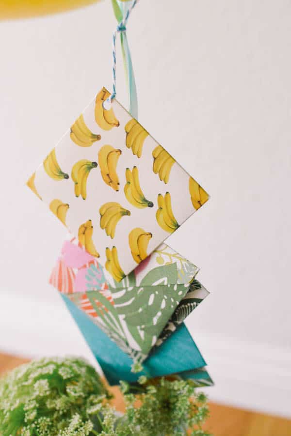 patterned envelopes attached to a balloon bouquet
