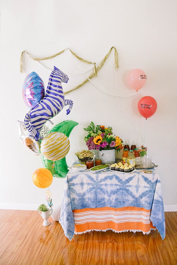 small party table set up at home with a balloon bouquet gift idea with giant zebra balloon set up next to it