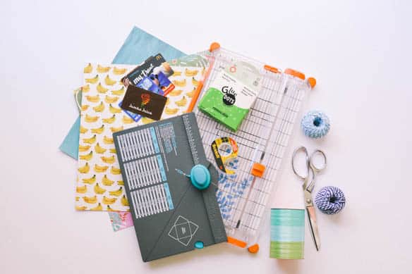Supplies and tools to make a Balloon Bouquet Bucket with gift cards attached