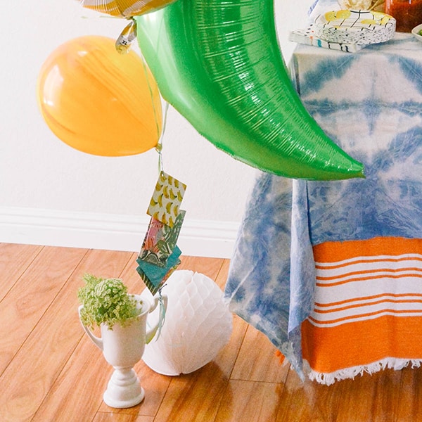 Trophy holding a bunch of balloons.