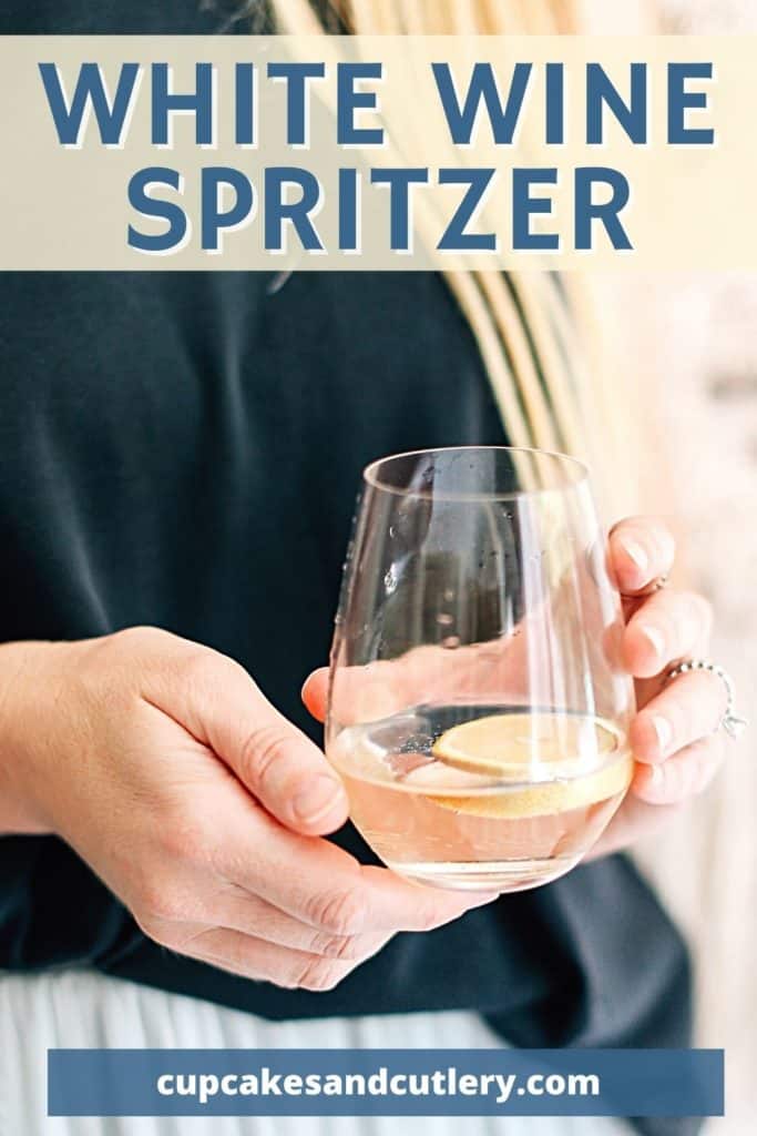 Woman holding a wine glass in her hands with text that says "White Wine Spritzer".