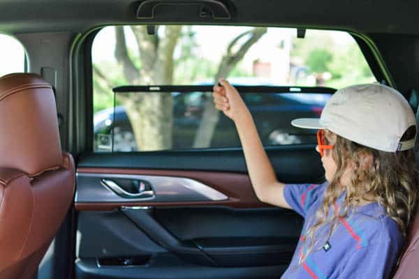 Child in the back seat of the Mazda Cx9.