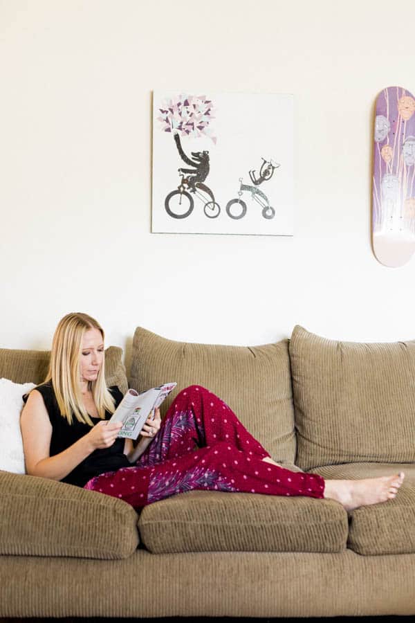 Woman reading a magazine on the couch. 