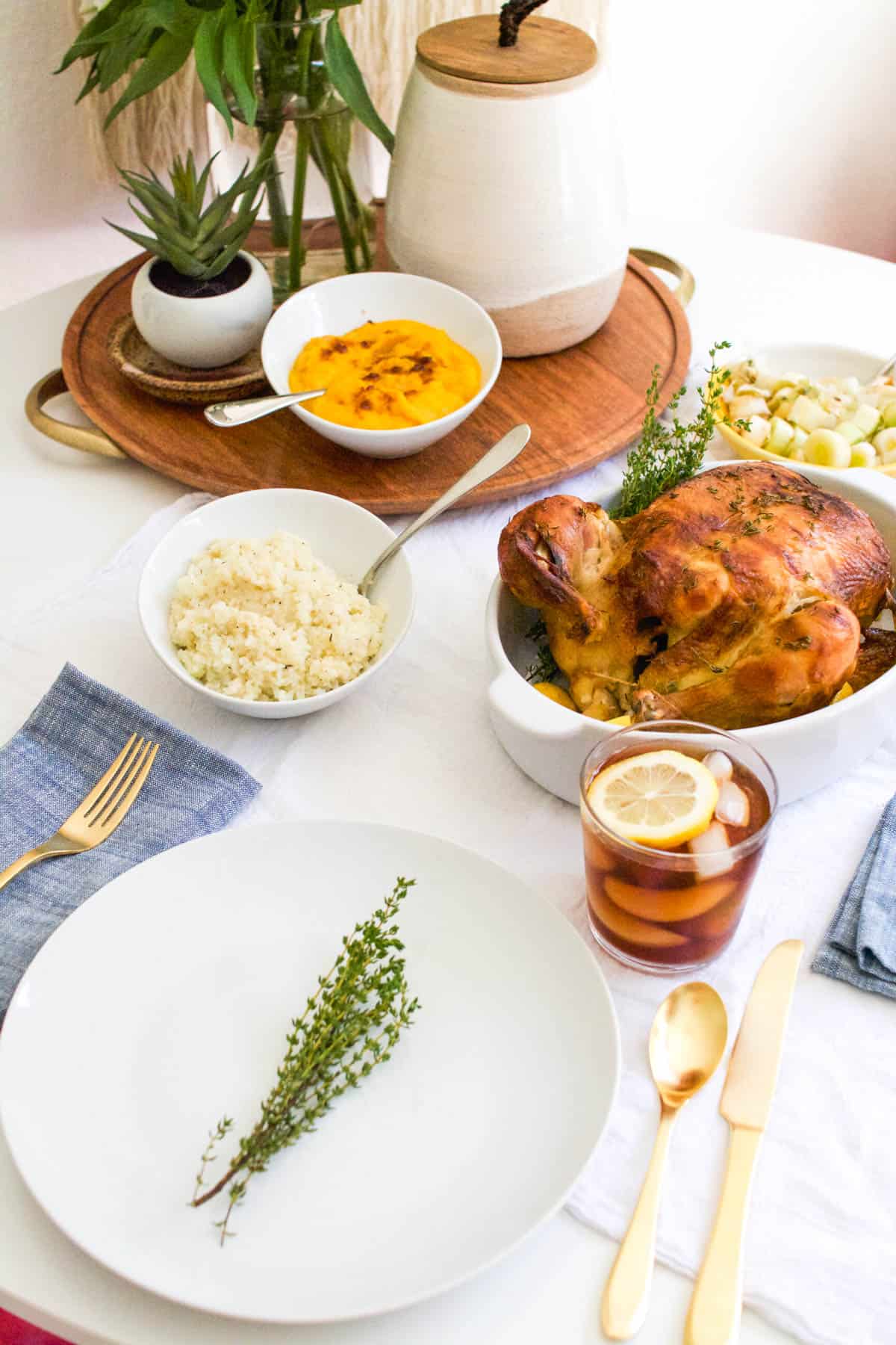 A dinner table with rotisserie chicken and healthy side dishes.