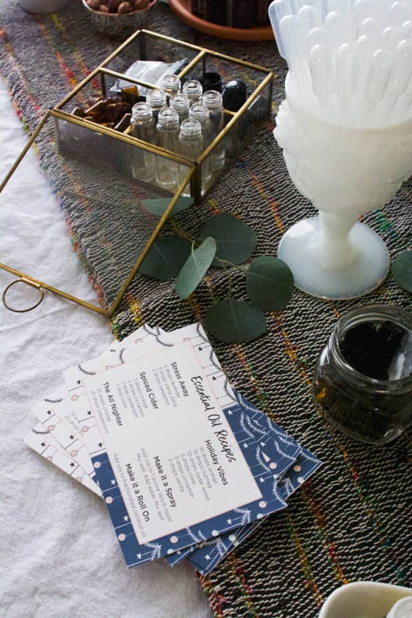 A decorative box with essential oils and some oil blend recipe cards on the table. 