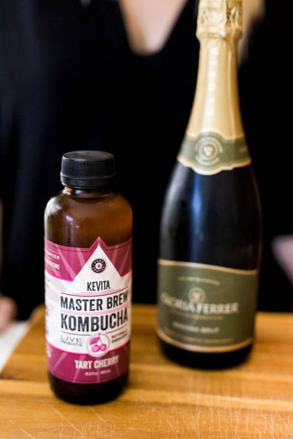 Bottles of cherry kombucha and champagne.