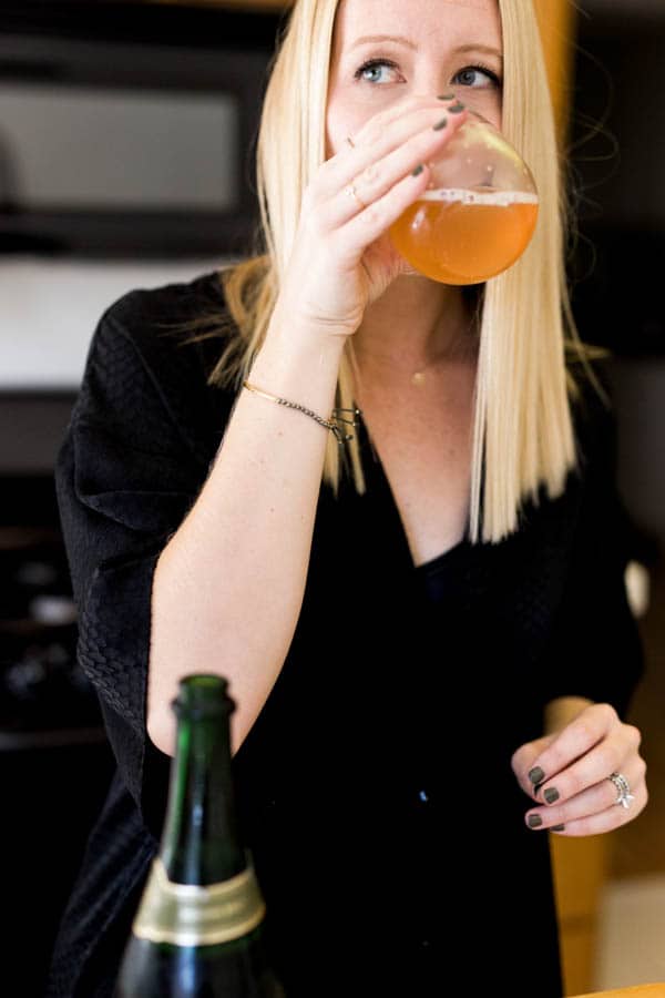 Woman drinking a kombucha mimosa.