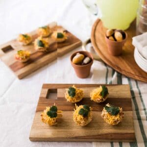 Taco Cups with chicken on serving trays on a party table.