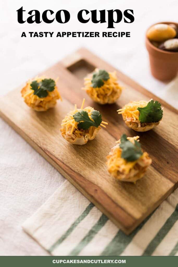 Close up of a tray with Chicken Taco Cups in phyllo topped with cheese and cilantro.