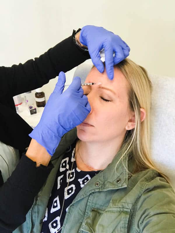 Blond woman getting Botox at CosmetiCare in Newport Beach.