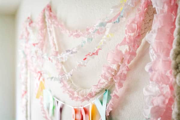 Ruffled party streamers used to decorate a wall for a party.