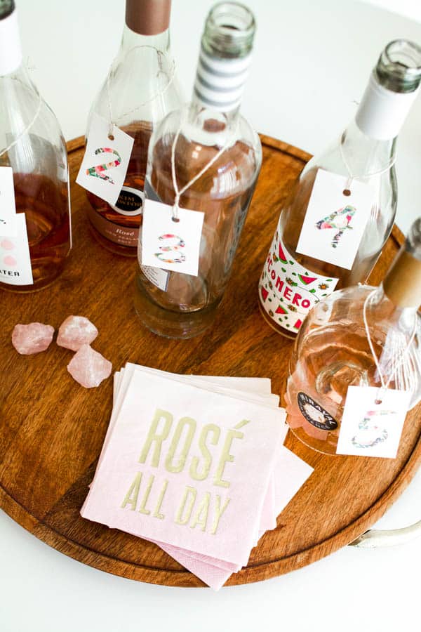 Empty rose bottles on a table with numbers on the necks for a tasting. 