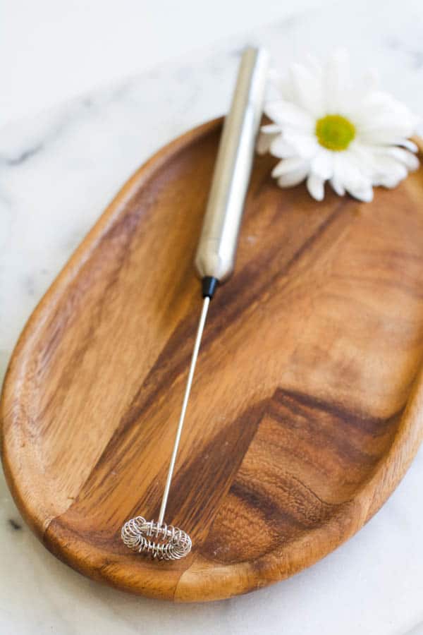 Battery operated milk frother for mixing wellness supplements.