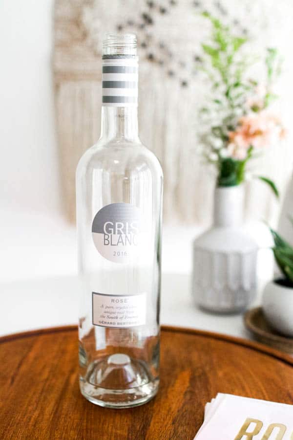 An empty bottle of Gris Blanc on a wooden tray. 