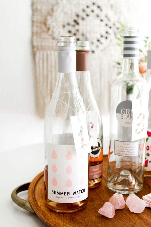 An open bottle of Summer Water rose in front of other rose bottles on a table. 