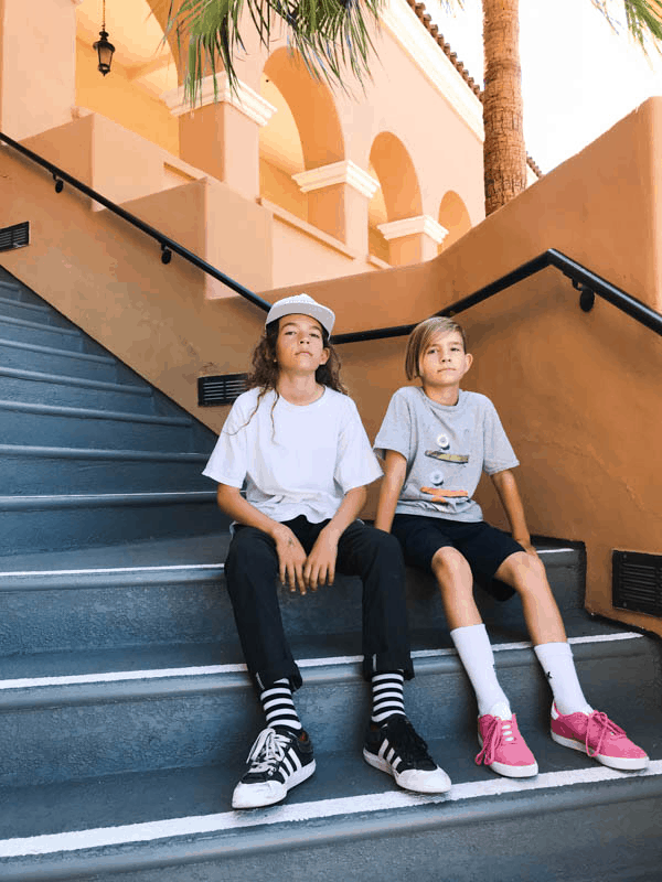 Tween boys sitting on stairs