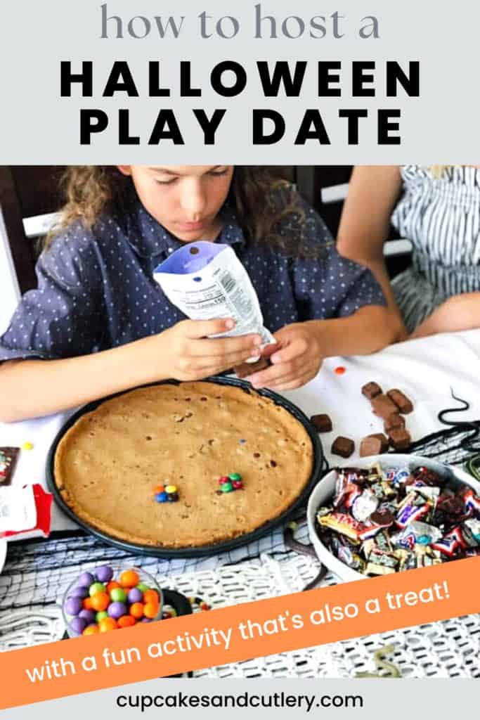 Text. - how to host a Halloween Playdate, kid decorating a giant cookie with bowls of candy near him on the table.