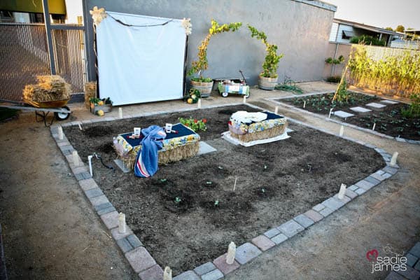 Outdoor movie night screen and seating ideas in a garden.