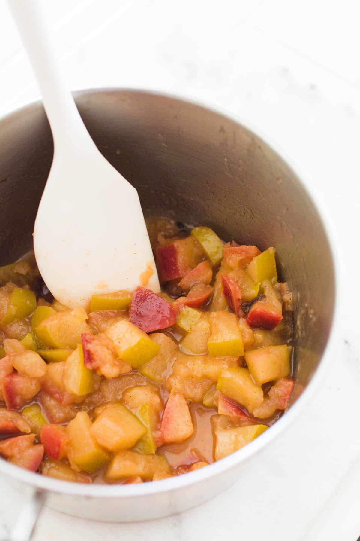 Cooked apples in a saucepan.