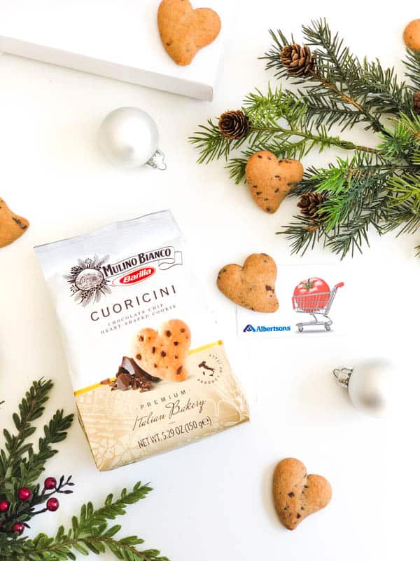 Mulino Bianco Cuoricini cookies next to holiday ornaments and an Albertson's gift card.