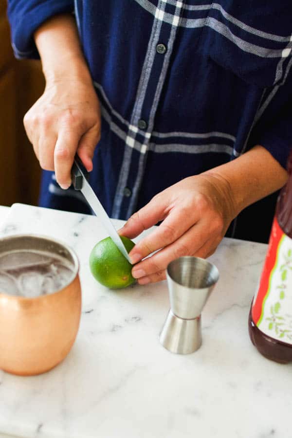 Woman cutting a lime.