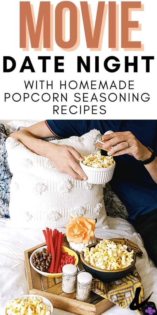 Man eating from a bowl of popcorn with a movie night snack tray in front of him.