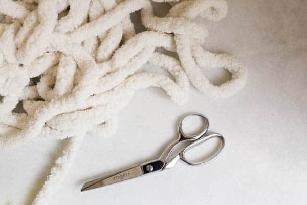 supplies for a diy knotted yarn garland
