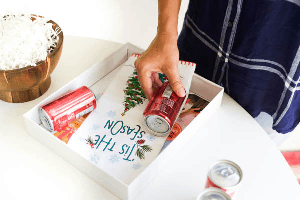 Putting items in a gift box for an easy girlfriend gift idea. 