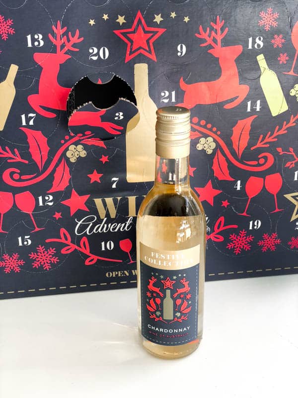 Wine advent calendar with a small bottle of wine in front.
