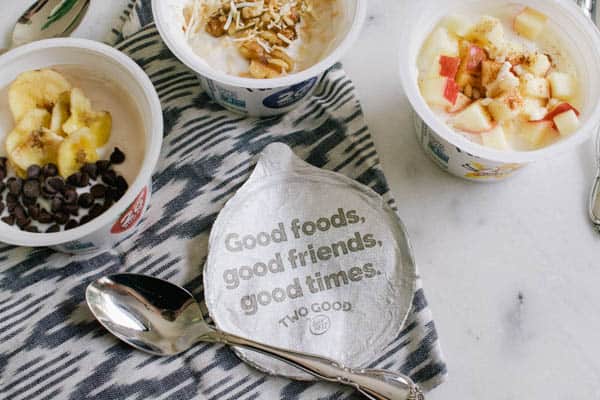 Yogurt containers with fun bits of fruit, nuts and coconut on top.