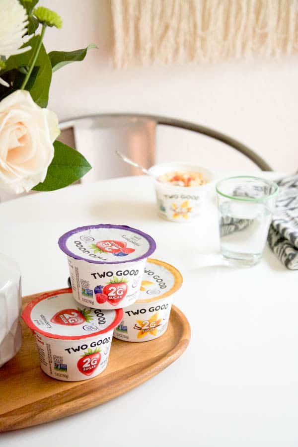 Yogurt containers stacked on top of each other on a table. 