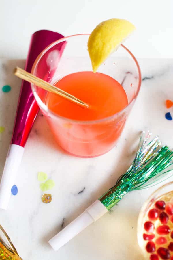 Noisemakers around a new years drink for kids.