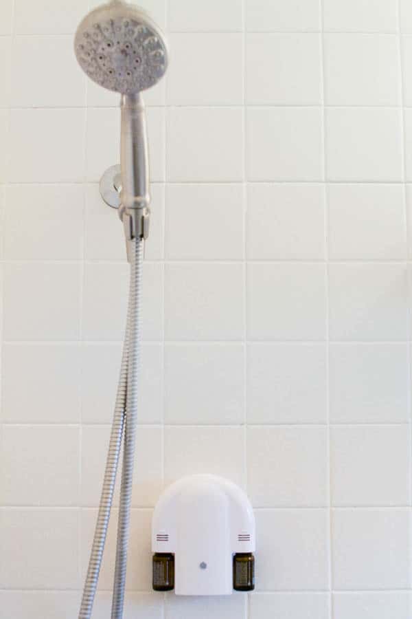 Dual scent essentail oil diffuser on a shower wall. 