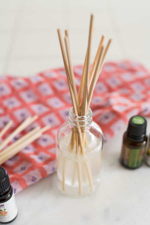 Close up of a homemade reed diffuser for essential oils.